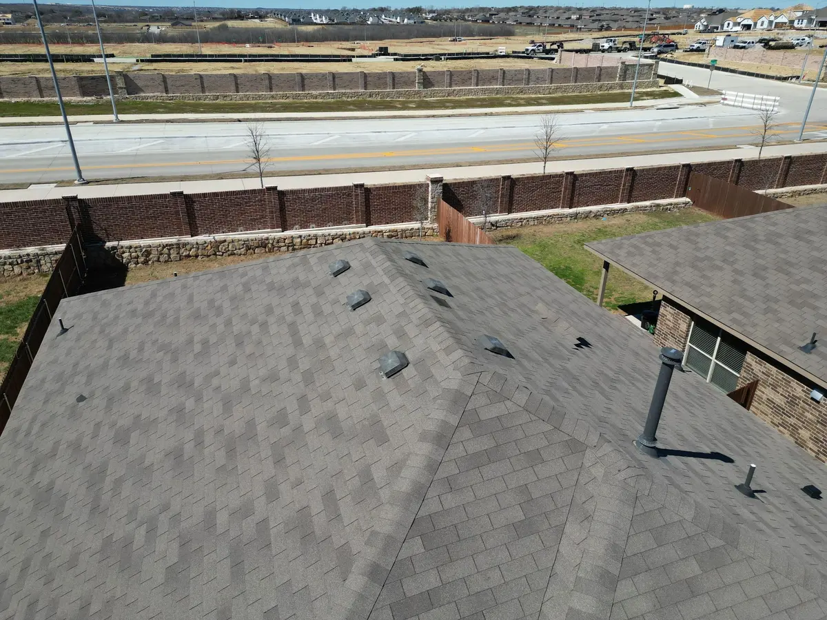 Worn and storm-damaged shingles photographed during an inspection