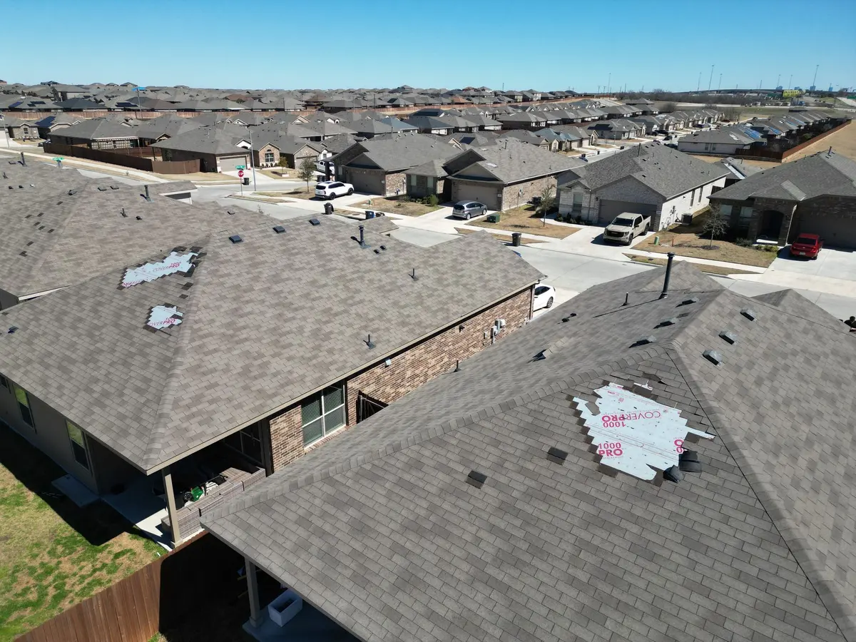 Aerial view of shingle roofs across a North Texas neighborhood