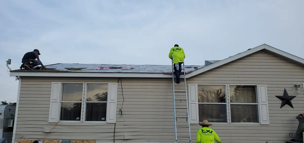 TXR crew member on a ladder at a home