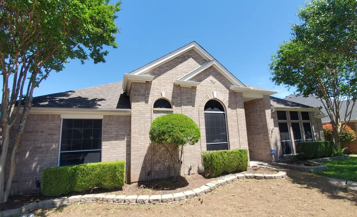 Brick home in Arlington with a newly replaced shingle roof by Texas Republic Roofing