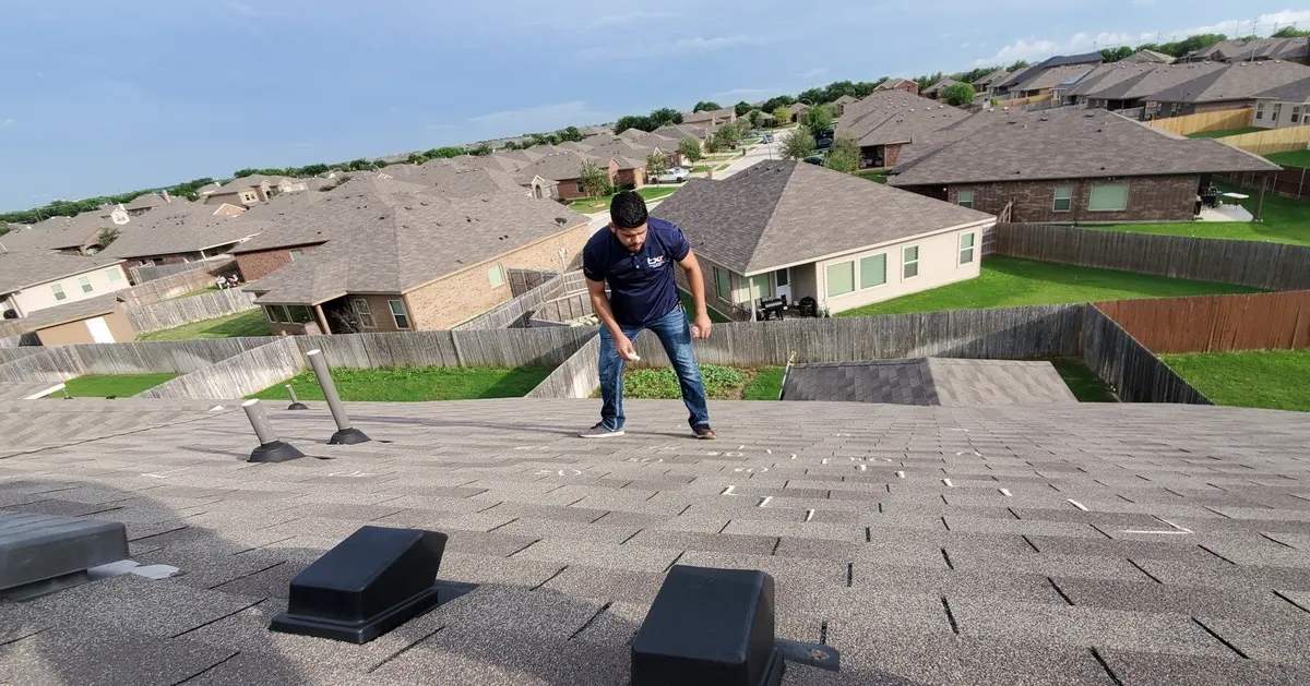 TXR crew member working on a rooftop in North Texas